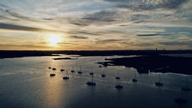 istock Sunset on water bay, rows of sailing boats moored 1364199247