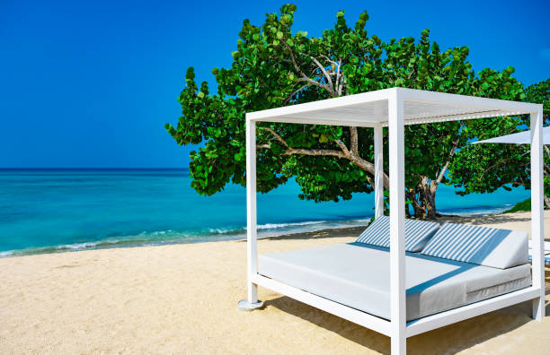 istock white bed on the sandy beach of the sea 1364201487
