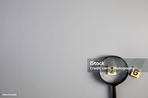 2g On Gray Background With Magnifying Glass For Covi19 Ccoronavirus Pandemic Rules Concept Top View Copy Space Stock Photo - Download Image Now