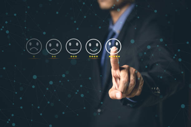 istock Customer Service and Satisfaction Concept Businessmen touch the virtual screen on happy smiley icons to achieve service satisfaction and feedback with excellent rated reviews. 1364202804