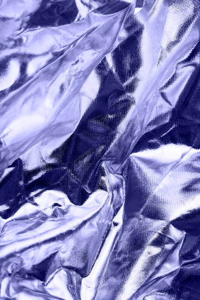 istock Shiny crumpled foil surface for textured background. Backdrop for your design. Toned in trendy color of year 2022. 1364203590