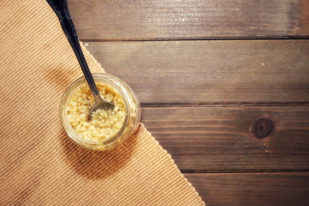 A jar of minced garlic on a wooden table