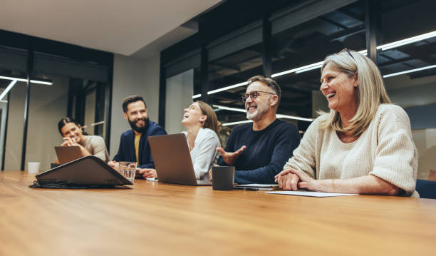 istock Cheerful businesspeople laughing during a meeting 1364207981