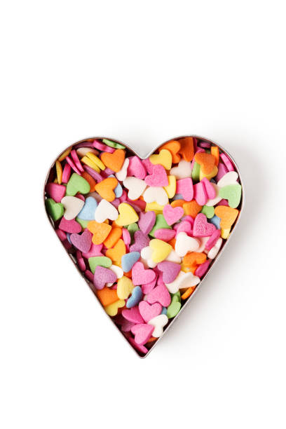 istock Multi-colored heart-shaped pastry topping in heart form on white background 1364208306