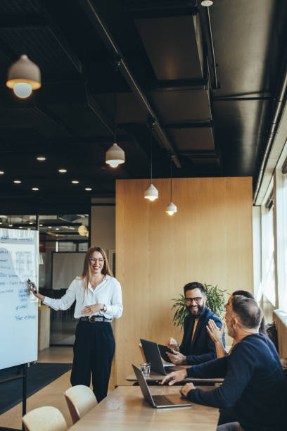 istock Cheerful businesspeople smiling during a presentation 1364208316