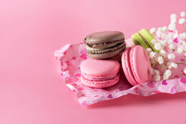 istock Macarons of Different Color on Pink Background Horizontal Copy Space 1364208490