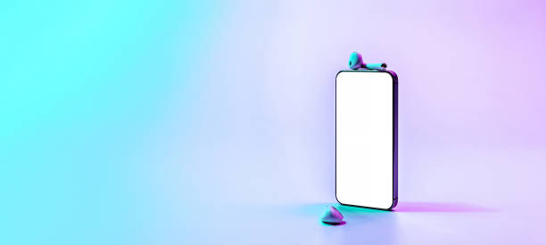 istock Screen mockup. Mobile smartphone technology blank screen. Mock up smart phone device, audio headphones on neon gradient banner. Game design, mobile application presentation or portfolio mockups. 1364208882