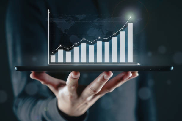 istock Business Man using a digital tablet with a business graph showing up on a virtual screen. Business growth and strategy, Stock market indicator concept. 1364209937