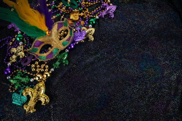 istock Mardi Gras Mask and colorful Mardi Gras Beads Background 1364210222