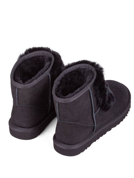istock Black winter woman's boots with fur on a white background 1364210416