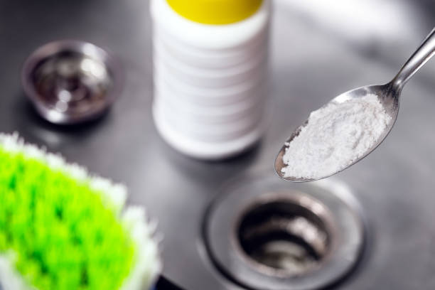 istock spoon with baking soda or sodium hydroxide powder, do it yourself, cleaning the kitchen sink 1364213011