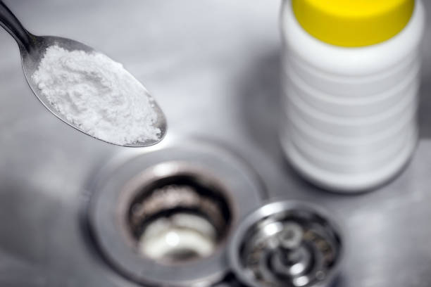 istock spoon with baking soda or sodium hydroxide powder, to unclog the kitchen sink drain 1364213014