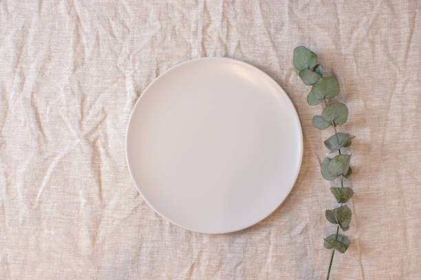 istock White colored circle shaped ceramic plate on isolated background, food mockup 1364214102