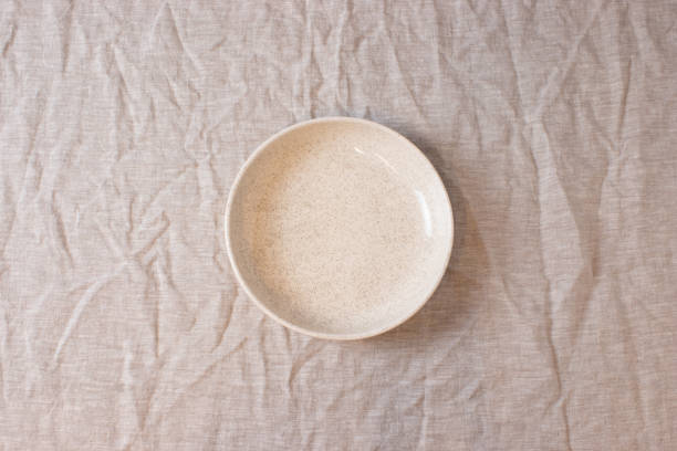 istock White colored circle shaped ceramic plate on isolated background, food mockup 1364214331