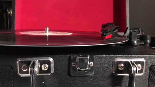 record player with needle on spinning vinyl