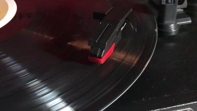 Top View record player with needle on spinning vinyl