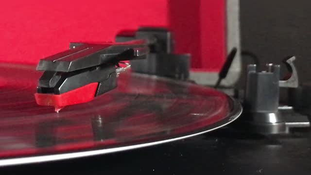 Side view  record player needle on spinning vinyl