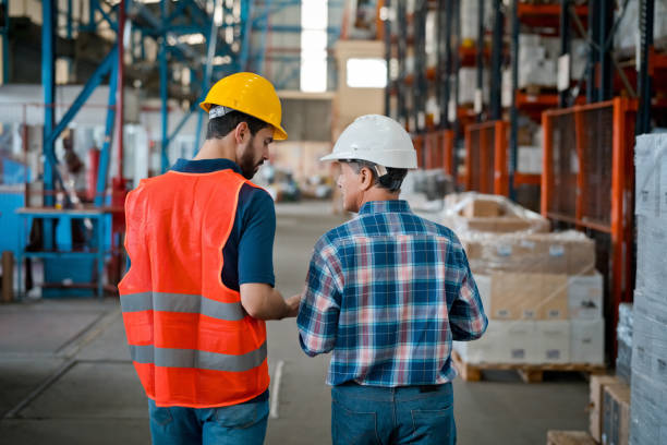 istock Male worker talking with manager in warehouse 1364219992