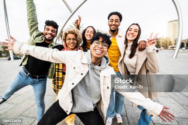 Big Group Of Happy Friends Stands Together On City Street With Raised Arms Multiracial Young People Having Fun Outside Volunteer With Hands Up Showing Teamwork Spirit Community And Friendship Stock Photo - Download Image Now