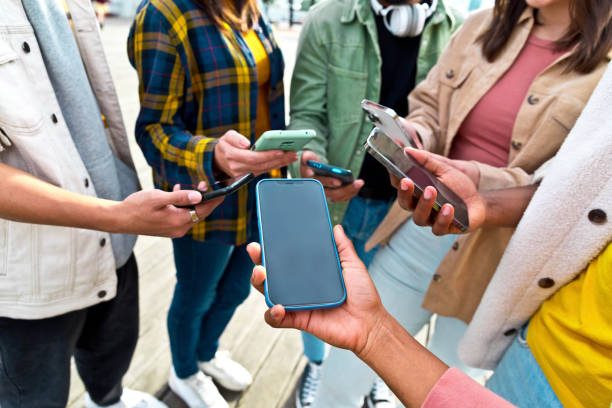 istock Group of young people using smart mobile phones - Multiethnic group of millennials watching cellphones outdoors - Technology addiction and youth lifestyle concept with guys and girls on social media 1364222702