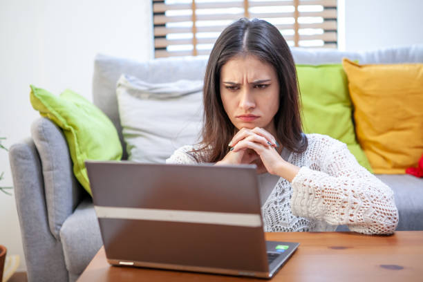 istock Young woman with laptop computer, office worker tired and has a headache. 1364225826