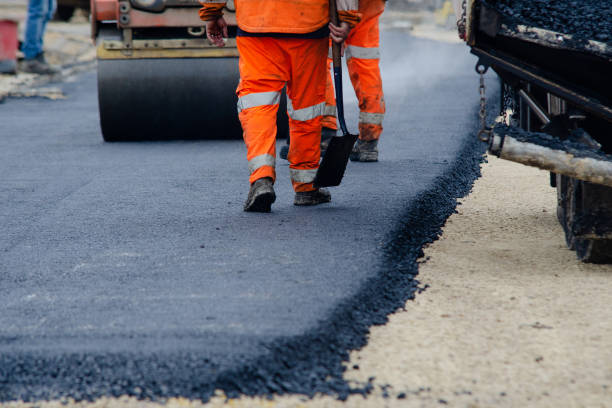 Roadworkers placing hot tarmac new road construction project Roadworkers placing hot tarmac new road construction project road construction stock pictures, royalty-free photos & images