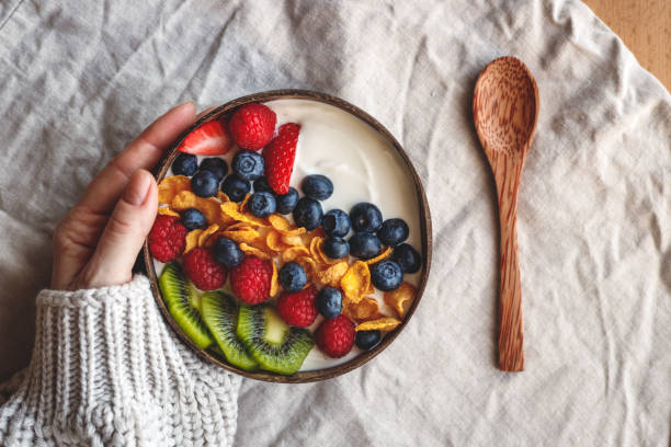 istock Healthy breakfast in coconut bowl on table with linen tablecloth 1364226089