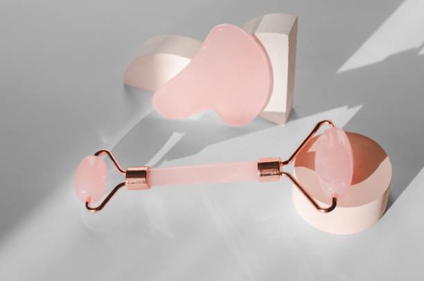 istock Roller jade facial massager on a white background with sharp shadows. Skin care 1364229705