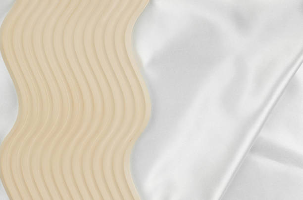 istock Geometric podium on white silk fabric with place for text or product advertisement 1364229779
