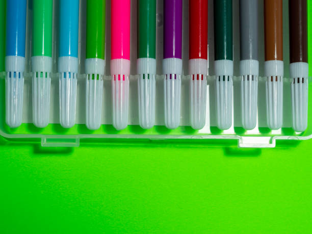 istock Colored markers on a green background 1364233595