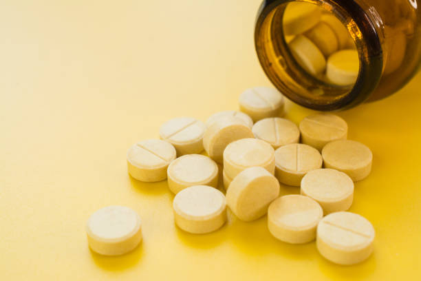 istock A bunch of pills on a yellow background 1364234906