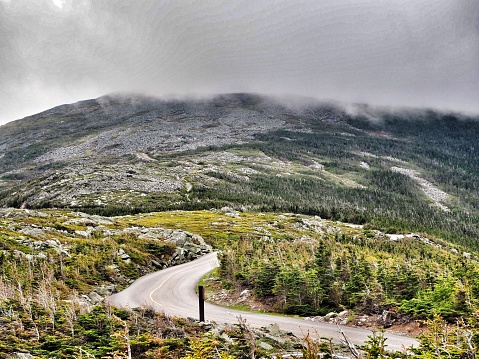 The Mount Washington Auto Road, empty and winding towards the base of a mountain, New Hampshire, USA