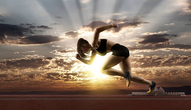 istock Woman sprinter leaving starting blocks 1364238795
