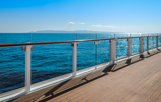 Safety railing of luxury cruise ship. Calm sea, blue sky. Cruise ship sailing on the Aegean Sea in summer. No people.