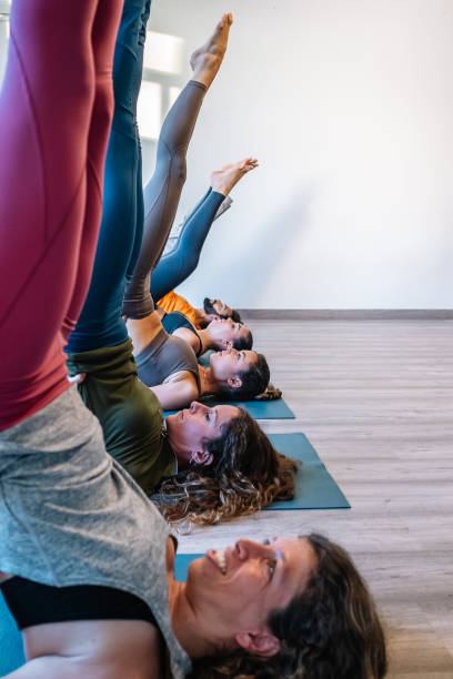 istock Group doing Salamba Sarvangasana pose together 1364240050