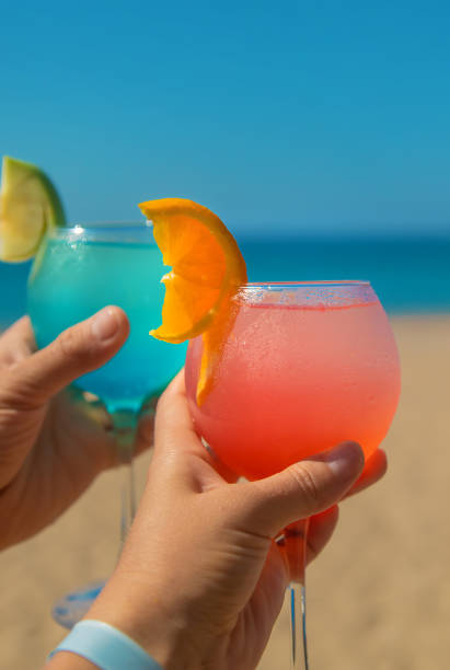 istock Woman on the beach holding a cocktail in her hands. Selective focus. 1364241727