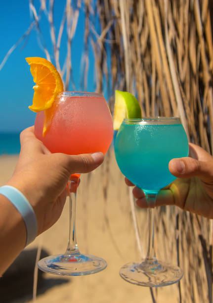 istock Woman on the beach holding a cocktail in her hands. Selective focus. 1364241730