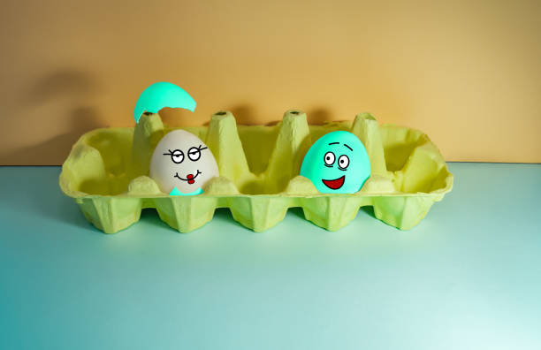 istock Funny eggs with faces with different facial expressions in a box. A love couple. Easter. Pastel colors 1364244571