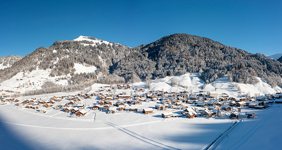 Aerial view panorama of a snow-covered village in the mountains. Vorarlberg, Schoppernau