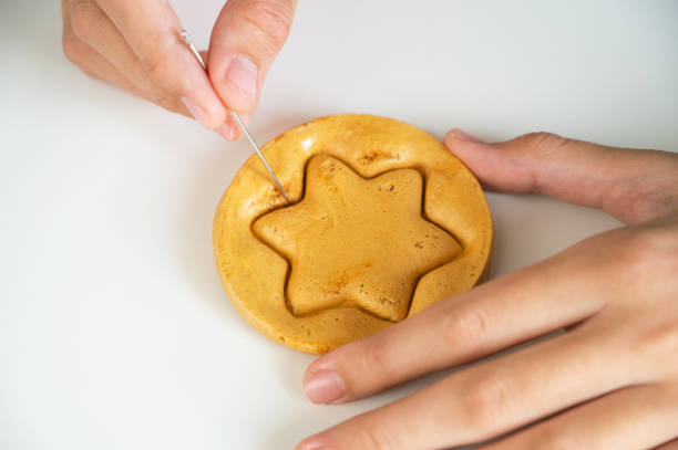 istock Hands closeup scratch brown sugar caramel candy cookies 1364246184