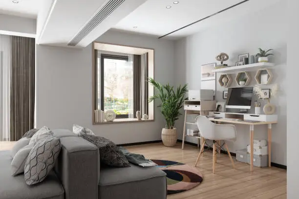 Photo of Working At Home. Home Office Interior With Wooden Table, 
Blank Screen Monitor, Gray Color Sofa And Garden View From The Window.