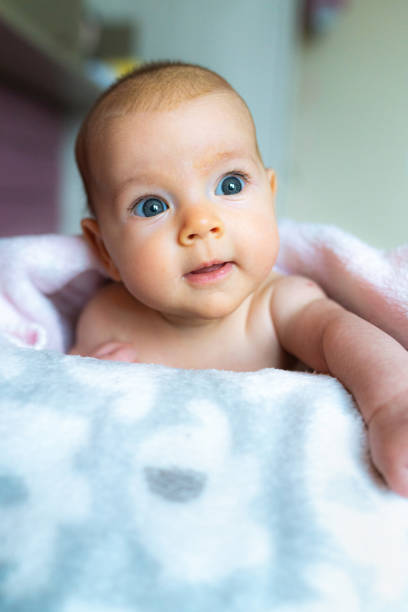 Cute baby girl lying on bed
