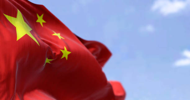 Detailed close up of the national flag of China waving in the wind on a clear day Detailed close up of the national flag of China waving in the wind on a clear day. Democracy and politics. Asian country. Selective focus. chinese flag stock pictures, royalty-free photos & images