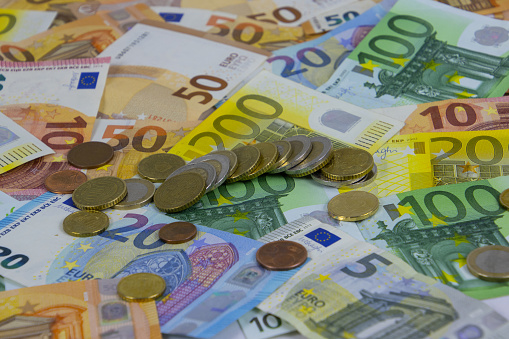 Euro coins lying on euro bill banknotes for financial background