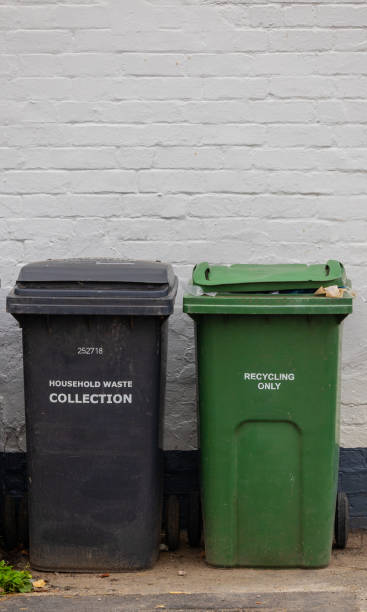 istock General waste and recycling wheelie bins against painted wall 1364252481