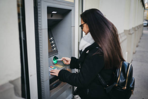 istock A woman uses an ATM 1364255167