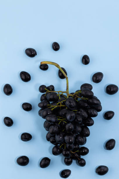 istock Fresh ripe grapes on a blue background 1364255533