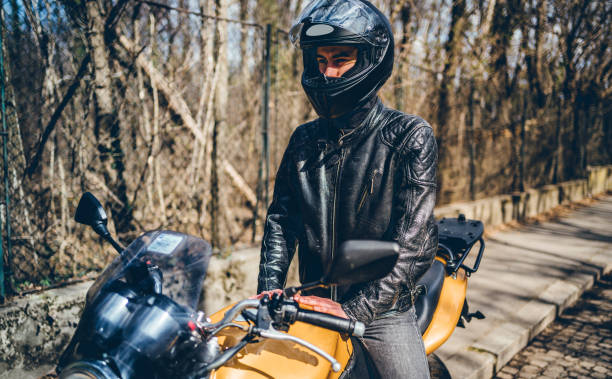 istock Man with helmet on motorcycle 1364255552