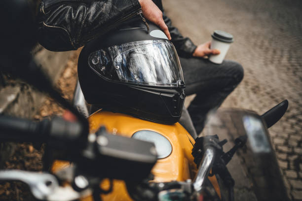 istock Man with coffee  next to the his motorcycle 1364255629