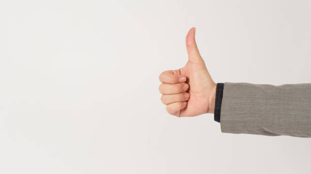 istock The hand is doing like hand sign in a grey suit on white background. Studio shooting. 1364256195